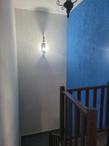 a light hanging from a wall next to a staircase at Pousada Empresarial in Mariana +15 photos