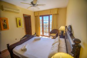 a bedroom with a large bed and a balcony at Mediterranea 10 tus momentos junto al mar Villaricos in Cuevas del Almanzora