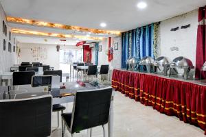 a dining room with tables and chairs and a unintention at FabHotel Prime Eco Park - New Town in New Town