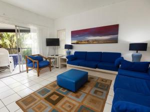 a living room with a blue couch and blue chairs at Ramsgate Beach Club in Ramsgate