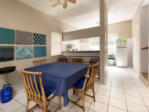 a dining room with a blue table and chairs at Ramsgate Beach Club in Ramsgate
