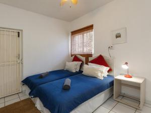 a bedroom with a blue bed and a window at Ramsgate Beach Club in Ramsgate +17 photos