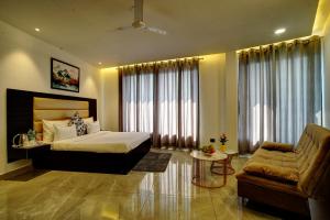 a hotel room with a bed and a couch at Hilltop Valley View Villa Nainital in Bhowāli