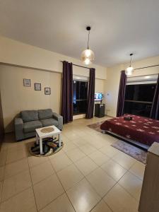 a living room with a couch and a bed at Master bedroom in JBR in Dubai