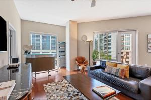 a living room with a leather couch and a table at Beautiful Downtown Condo 1 Bed 1 Bath in Orlando