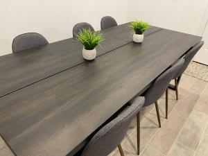 a wooden table with chairs and plants on it at 4-BR Cheerful Home Long Term Stay Equipped in Katy in Katy