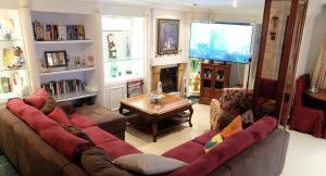 a living room with a large couch and a television at villa mijas with pool 50 m beach in Fuengirola