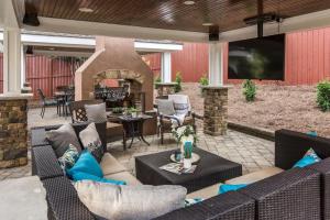 an outdoor patio with a couch and a fireplace at Luxe Large Home with Movie Room, Hot Tub, Garage in Nashville