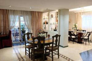 a dining room and living room with a table and chairs at villa mijas with pool 50 m beach in Fuengirola