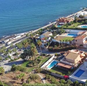 an aerial view of a resort and the ocean at villa mijas with pool 50 m beach in Fuengirola
