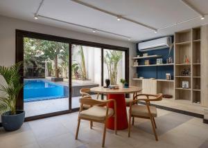a dining room with a table and chairs and a pool at Exclusive stay with luxury touches at 22 by spacey #55 Studio in Maadi in Cairo