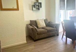 a living room with a couch and a table at Comfy Staycation! 2BR City Centre Westcliff Beach & High St by Everhome Ltd in Southend-on-Sea +1 photo