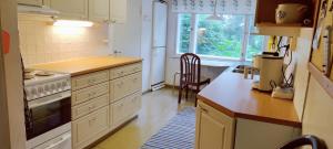 a kitchen with white cabinets and a stove top oven at Spacious Apartment for 8 with Sauna in Sievi +4 photos