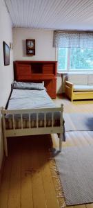 a bedroom with a bed and a dresser and a window at Spacious Apartment for 8 with Sauna in Sievi