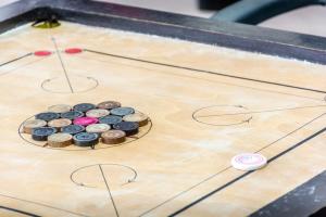 a game of shuffleboard with chocolates on it at Break the Routine, Malshej in Murbād