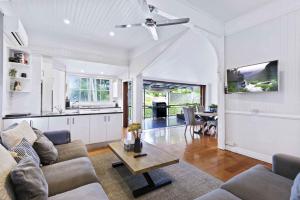 a living room with a couch and a table at Family Friendly, Pool, 9km to City by Custom Bnb Hosting in Brisbane