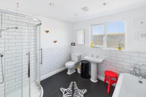 a white bathroom with a sink and a toilet at Host & Stay - The Artists Pad in Saltburn-by-the-Sea