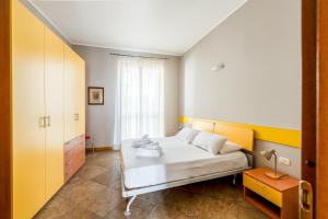 a bedroom with a white bed and a window at Residence Due Spade - Free Parking in Melzo