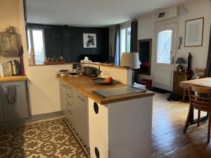 a kitchen with a counter top and a table at Maison Alfortville in Alfortville