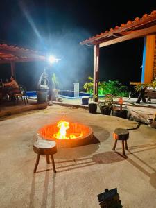 a fire pit in the middle of a patio at night at Margarida 01 in Monte das Gameleiras +4 photos