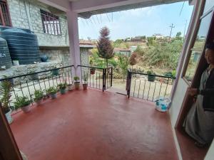 a view from the balcony of a house with potted plants at Ribha Homestay in Nongjrong