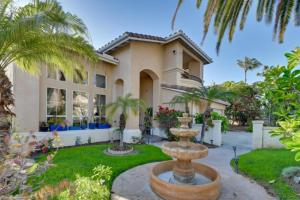 a house with a fountain in front of it at Coastal Haven in Encinitas