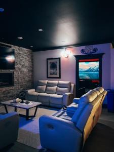 a living room with a couch and a television at Long Lake Escape in Hammonds Plains