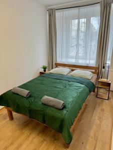 a large bed in a room with a large window at Nice rooms in City Center Kraków in Kraków