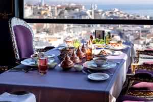 a table with a blue table cloth with food on it at AJWA Sultanahmet - Preferred Hotels LVX Collection in Istanbul +130 photos