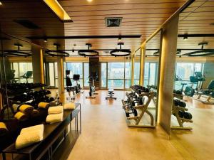 a gym with treadmills and exercise equipment in a building at Novotel Executive Suite - Acqua Manila in Manila
