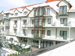 an apartment building with snow on the balconies at Zur guten Quelle in Brotterode