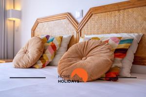 a bedroom with a bed with two pillows and a bed with a head board at #303 Atlantida Praia da Rocha by Home Holidays in Portimão