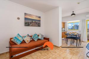 a living room with a couch and a table at #303 Atlantida Praia da Rocha by Home Holidays in Portimão