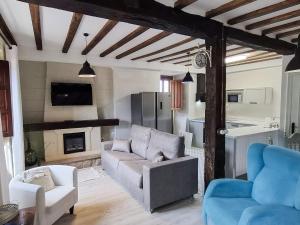 a living room with a couch and a fireplace at Casa Entrepeñas 3000 in Villegar