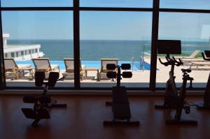 a gym with a view of the ocean and chairs at Celine - Infinity Pool & Spa Resort in Năvodari