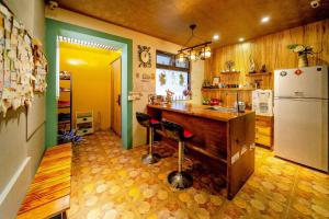 a kitchen with a counter and a refrigerator at Lazy Cat in Luodong +31 photos