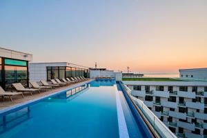 a swimming pool on the roof of a building at Celine in Infinity Pool & Spa Resort in Năvodari