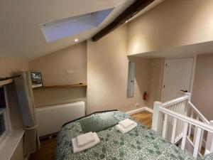 a bedroom with a bed with two towels on it at Low Fellside in Kendal