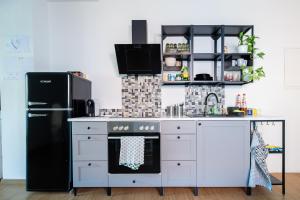 a kitchen with a black refrigerator and a stove at Gästehaus Tanja & Claus in Eisenstadt