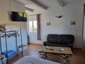 a living room with a couch and a table at La Fanette in Montbrison-sur-Lez