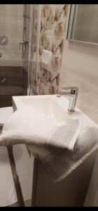 a bathroom sink with a white towel on it at Bed and breakfast Nika in Rab