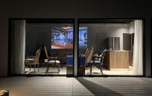 a living room with a sliding glass door and a kitchen at Anping Lounge in Tainan