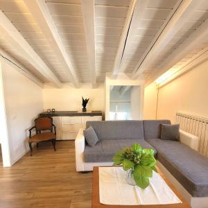 a living room with a couch and a table at Light on Lake Iseo in Clusane sul Lago
