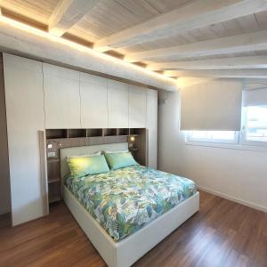 a bedroom with a large bed with a wooden ceiling at Light on Lake Iseo in Clusane sul Lago