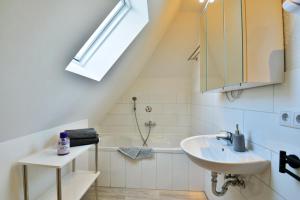 a bathroom with a sink and a bath tub at Parkvilla Köhler in Zella-Mehlis +37 photos