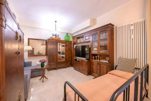 un soggiorno con un letto e una televisione di Magnificent rooms Verona Center a Verona