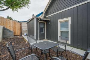 a patio with a table and chairs next to a building at MountainViews FirePit SmartTV AC WD SelfEntry in Colorado Springs