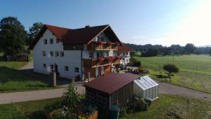 a large white house with a red roof at Ferienwohnung Steible in Isny im Allgäu