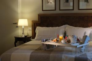 a hotel room with a tray of food on a bed at Residenza Paulonia in Volta Mantovana