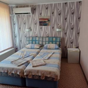 a bedroom with two twin beds in a room at Enjoy Guest House in Golden Sands +21 photos